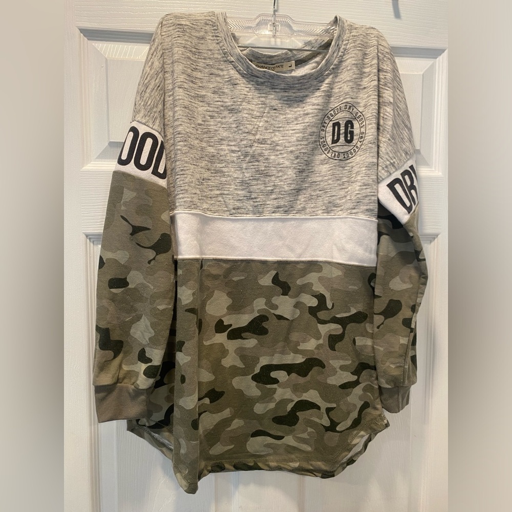 Woman’s long sleeve gray and army pattern shirt.